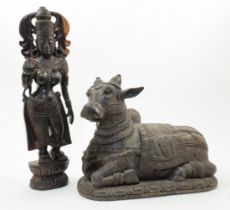 Two large Indian carved wood figures, 20th century, the first depicting the goddess Parvati stand...