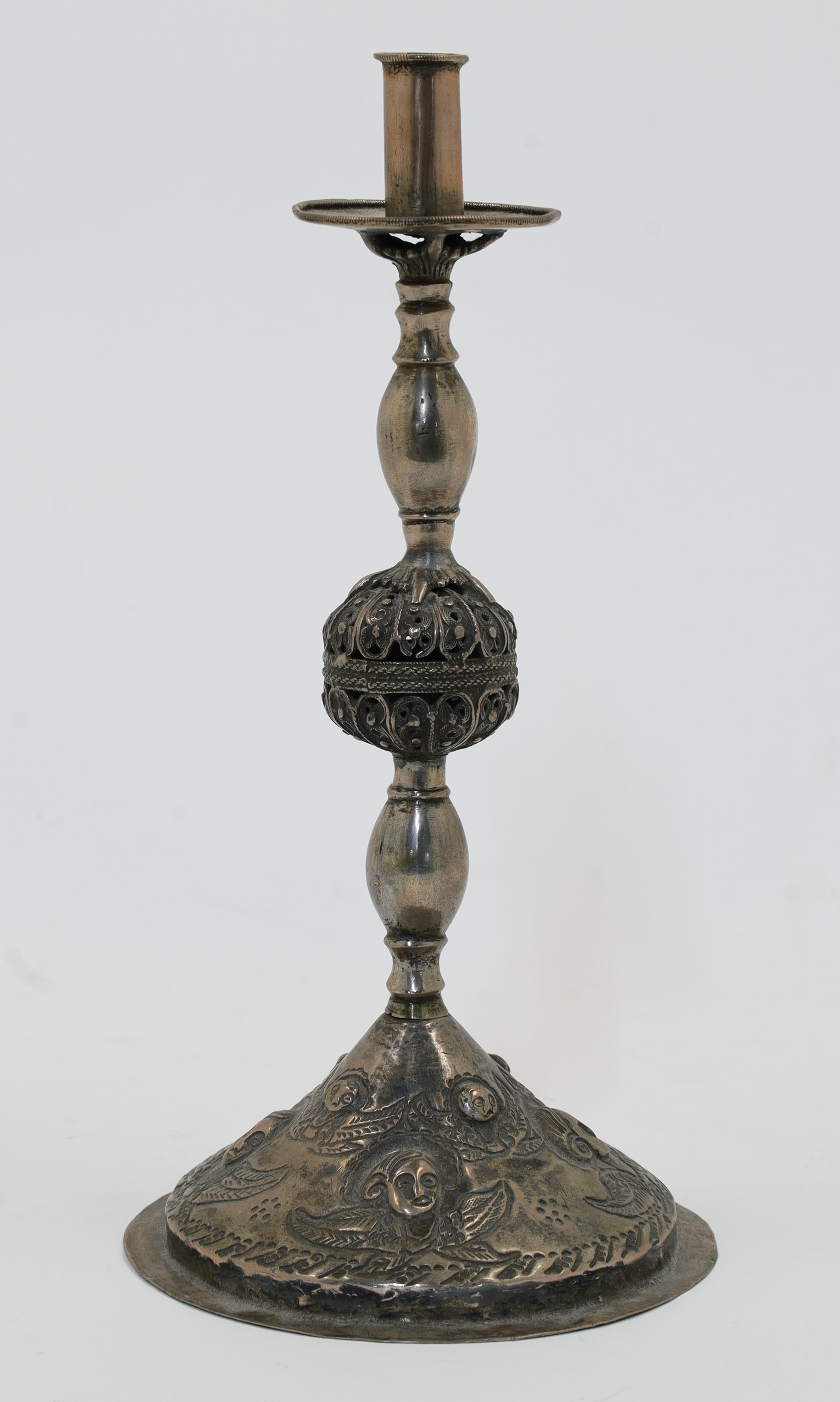 An Armenian silver repousse candlestick holder, Ottoman provinces, 19th century, on circular coni...