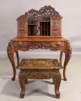 A South East Asian carved hardwood desk, 20th century, 139cm high, 113cm wide, 70cm deep, with as...