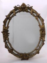 An oval giltwood mirror, in rococo taste, early 20th century,
