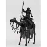 A metal sculpture of an Arab soldier with rifle riding a camel, 20th century, black painted tubul...