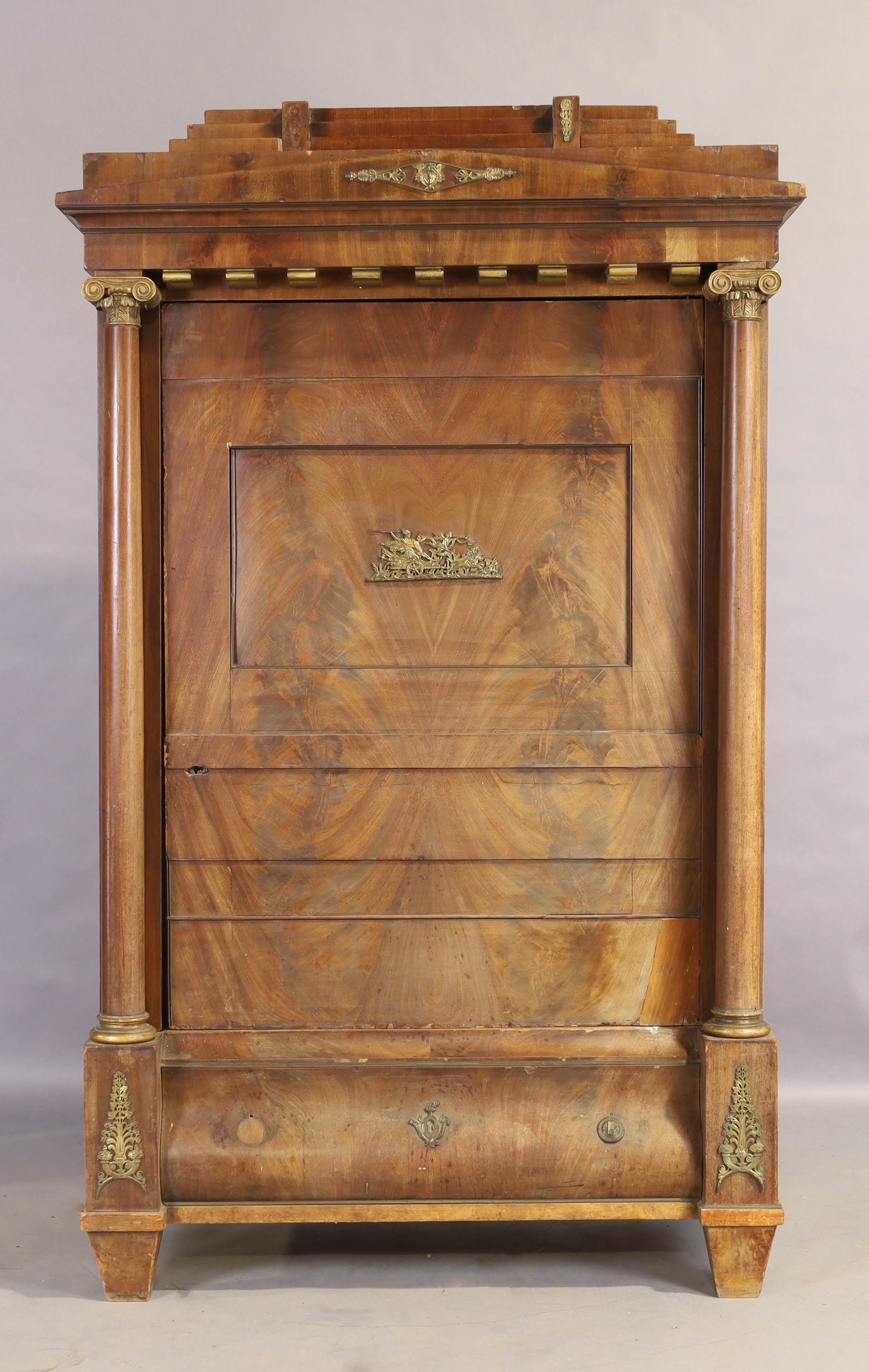 An Empire mahogany cabinet, first quarter 19th century, gilt metal mounted, the stepped and shape...