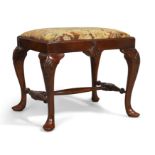 An English mahogany stool, of George II style, first quarter 20th century, with tapestry upholste...