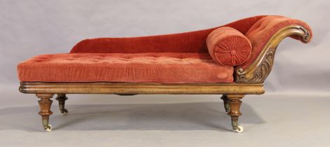 A Victorian mahogany chaise longue, third quarter 19th century, on turned legs to brass caps and ...