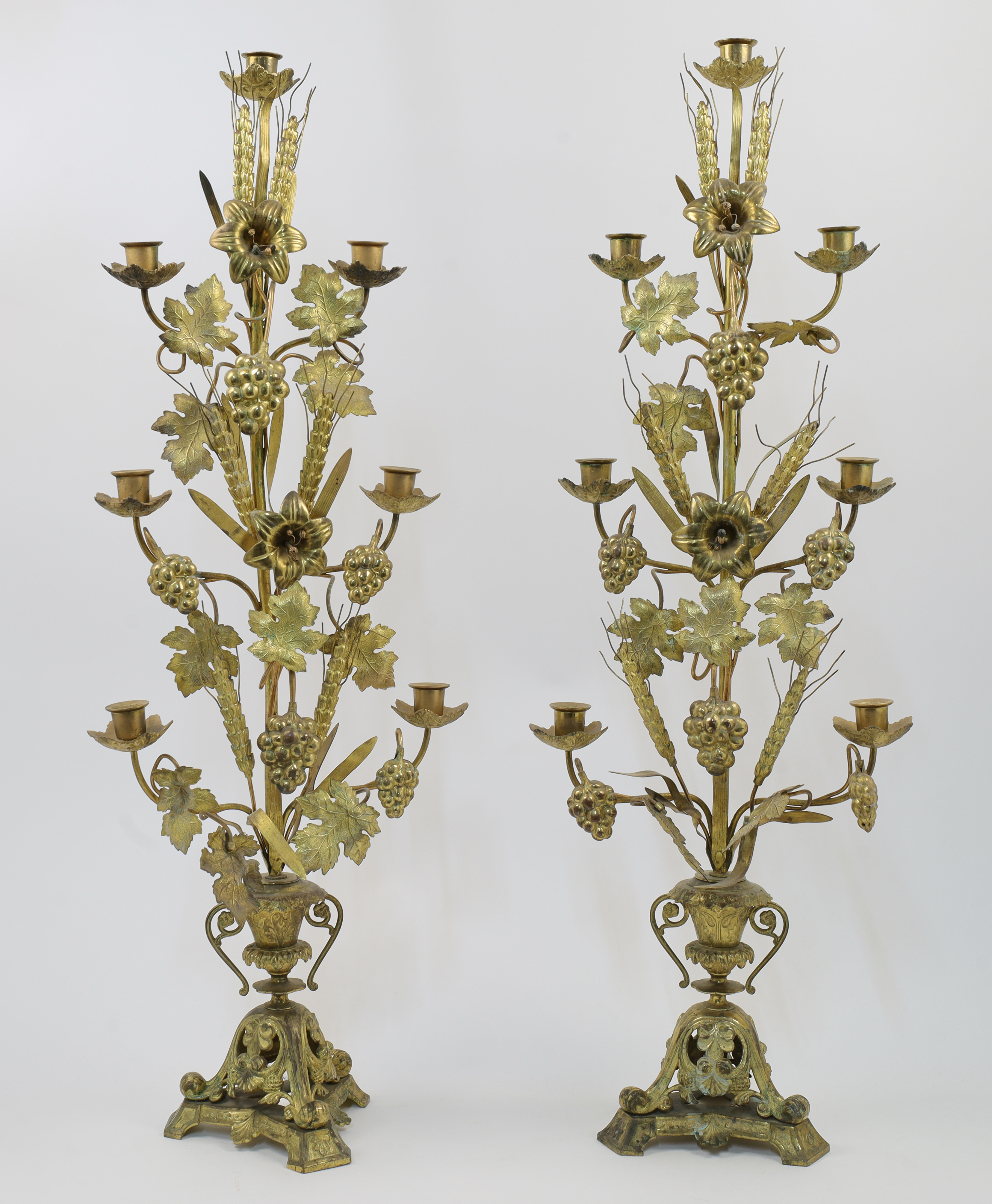 A pair of French gilt brass candelabra, late 19th century, each with seven sconces on branches is...