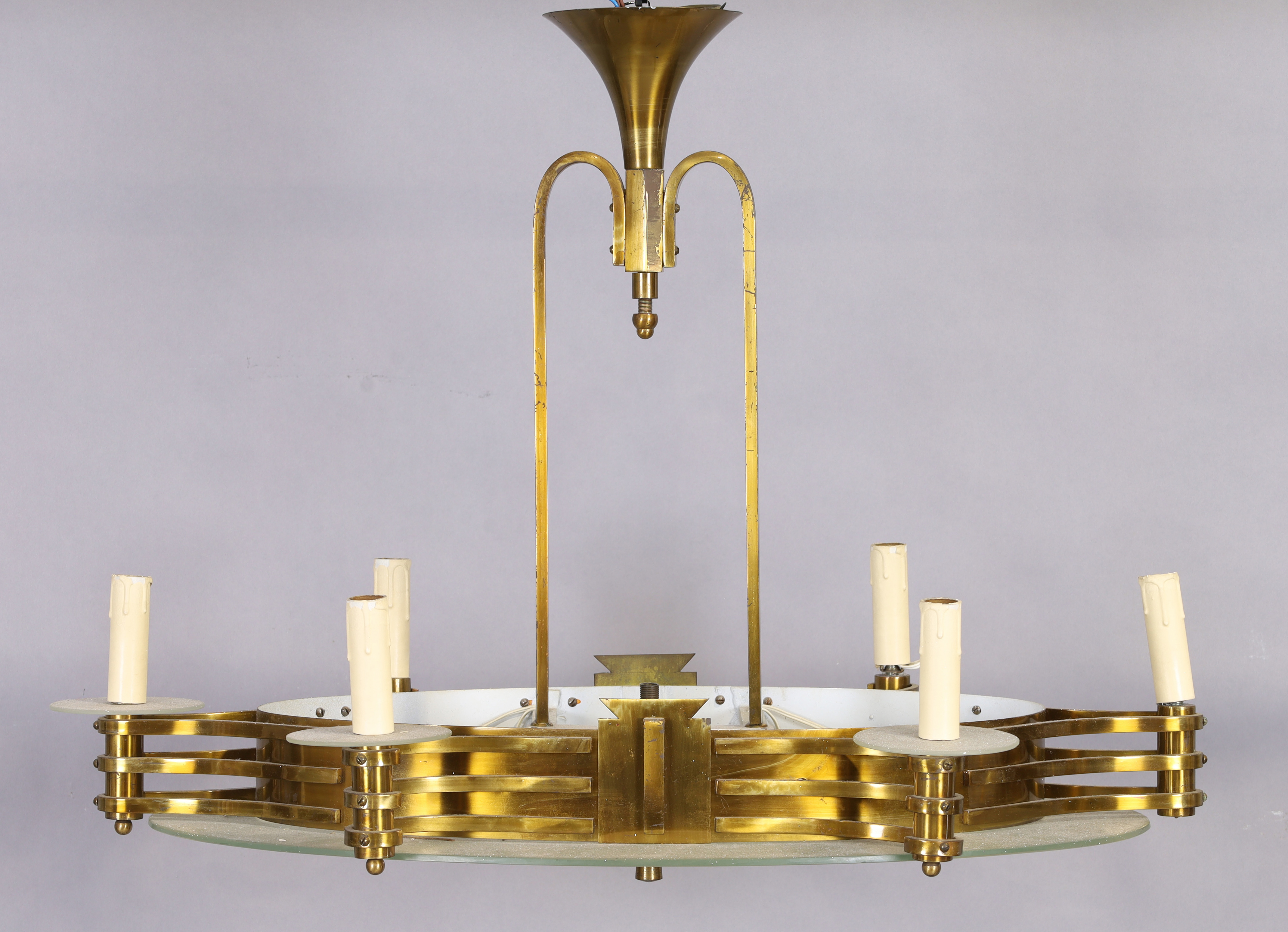 An Art Deco brass and frosted glass eight-light chandelier, 20th century, the oval brass frame wi...