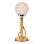 An Art Deco beech, bakelite and chromed metal table lamp, c.1930, with spherical glass shade, 53c...