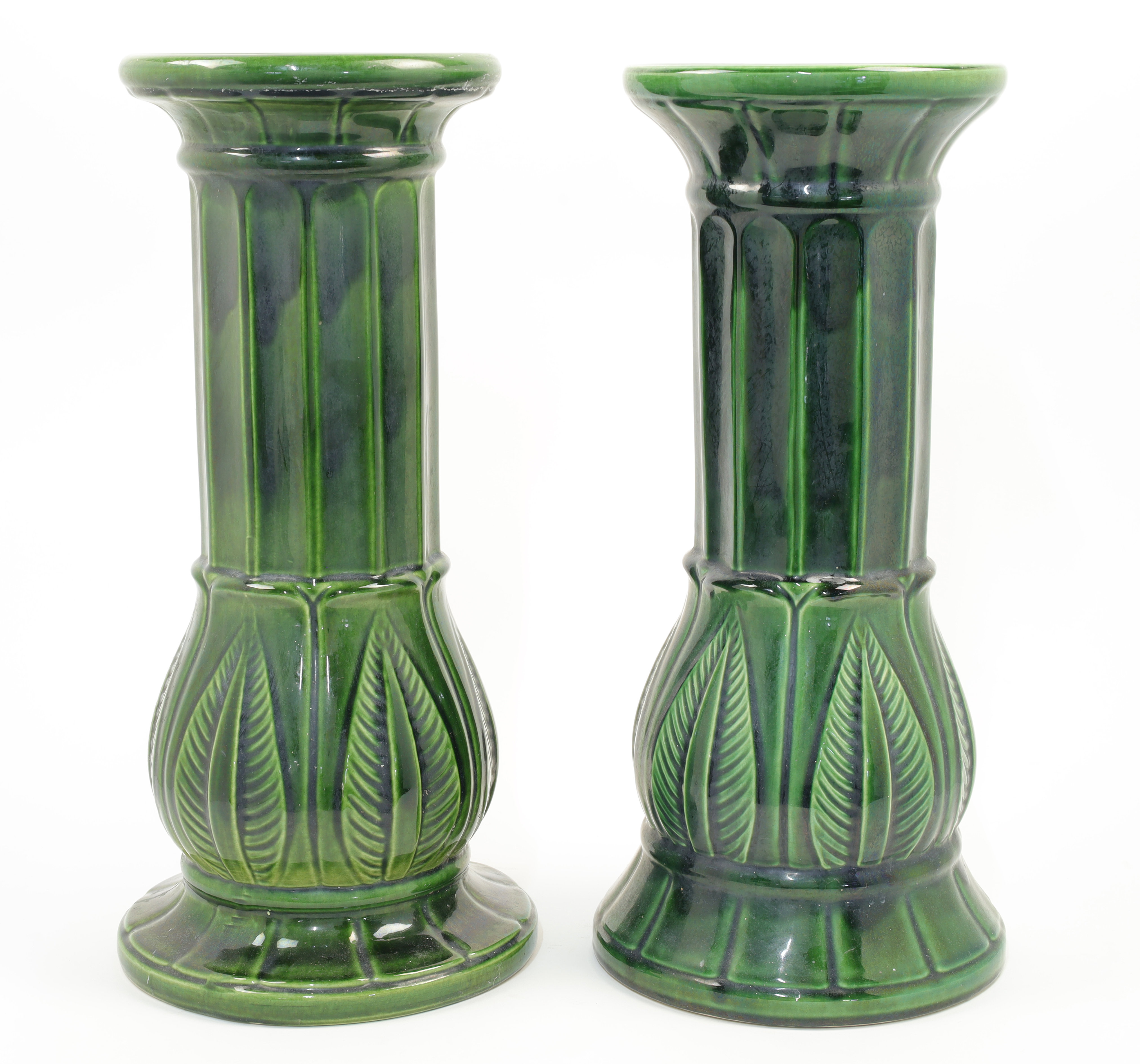 A near pair of West German green majolica jardiniere stands, 20th century, of columnar form with ...
