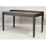 A contemporary ebonised desk, with hinged leather writing surface, revealing compartment, over si...