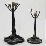 Two wrought iron table lamps in the manner of Edgar Brandt, 20th century, each with tapering stem...