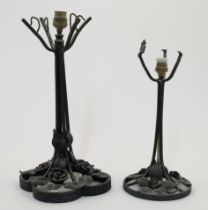 Two wrought iron table lamps in the manner of Edgar Brandt, 20th century, each with tapering stem...