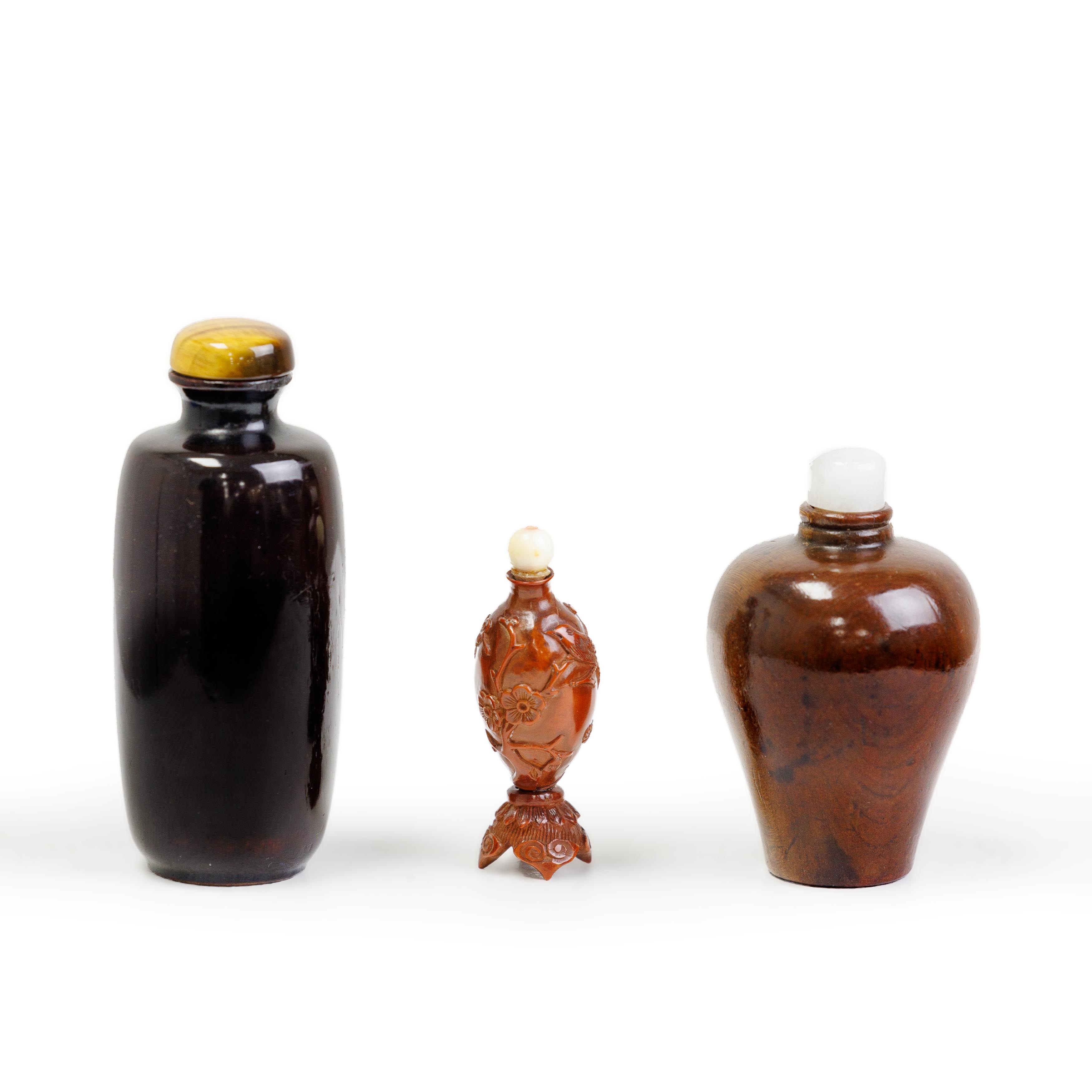 A Chinese carved hediao snuff bottle and two lacquered wood snuff bottles Qing dynasty, 18th cen...