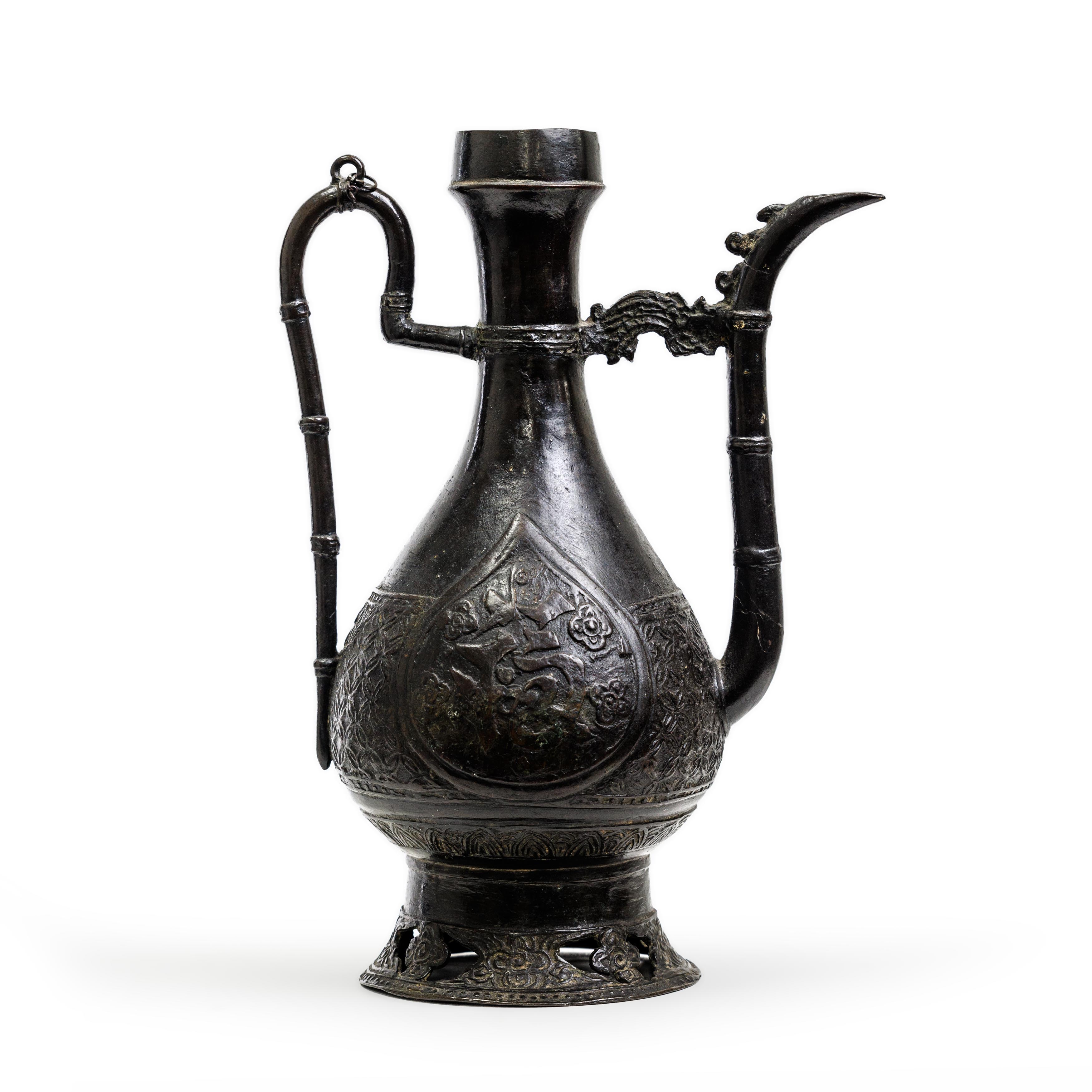 A Chinese bronze wine ewer Ming dynasty, Jiajing period Of typical pear-shaped form, with peach...