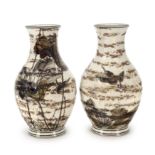 A pair of Japanese pottery baluster vases Meiji period Painted in enamels with birds above a l...