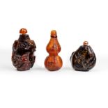 Three Chinese amber snuff bottles Late Qing dynasty The first, moulded and carved as a double g...
