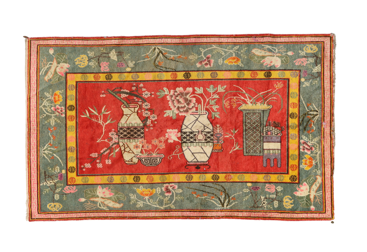 A Chinese rug Second quarter 20th century The central field with vase of flower motifs, on a re...