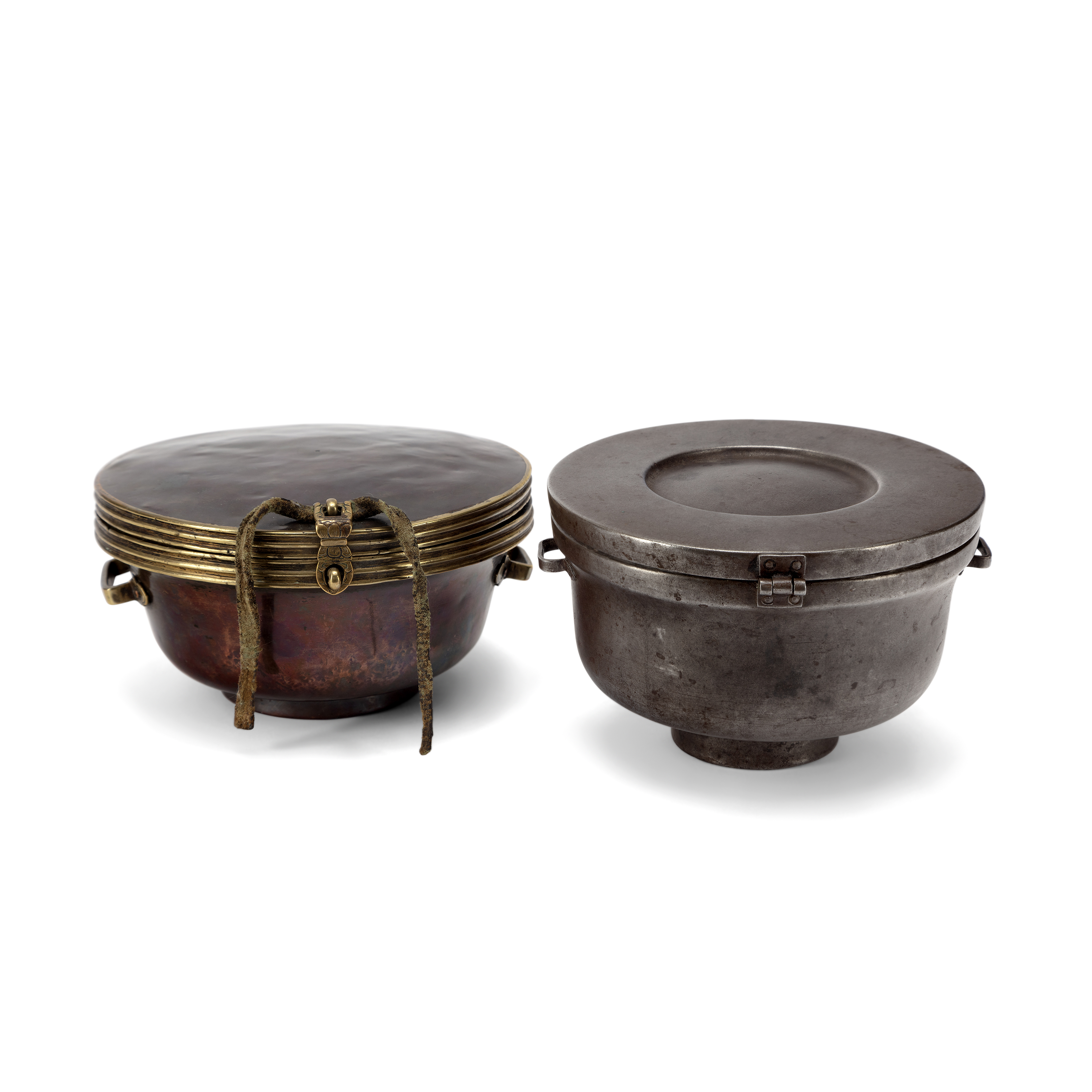 Two Tibetan copper alloy bowl cases 19th/20th century Comprising: a copper bowl case and hinged...
