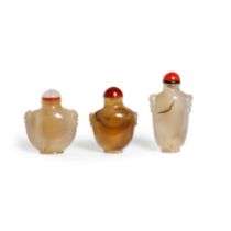 Three Chinese agate snuff bottles Qing dynasty, 18th century Each well-hollowed, standing on a ...