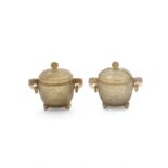 A pair of Chinese agate tripod handled bowls and covers Late Qing dynasty The bowls carved in s...