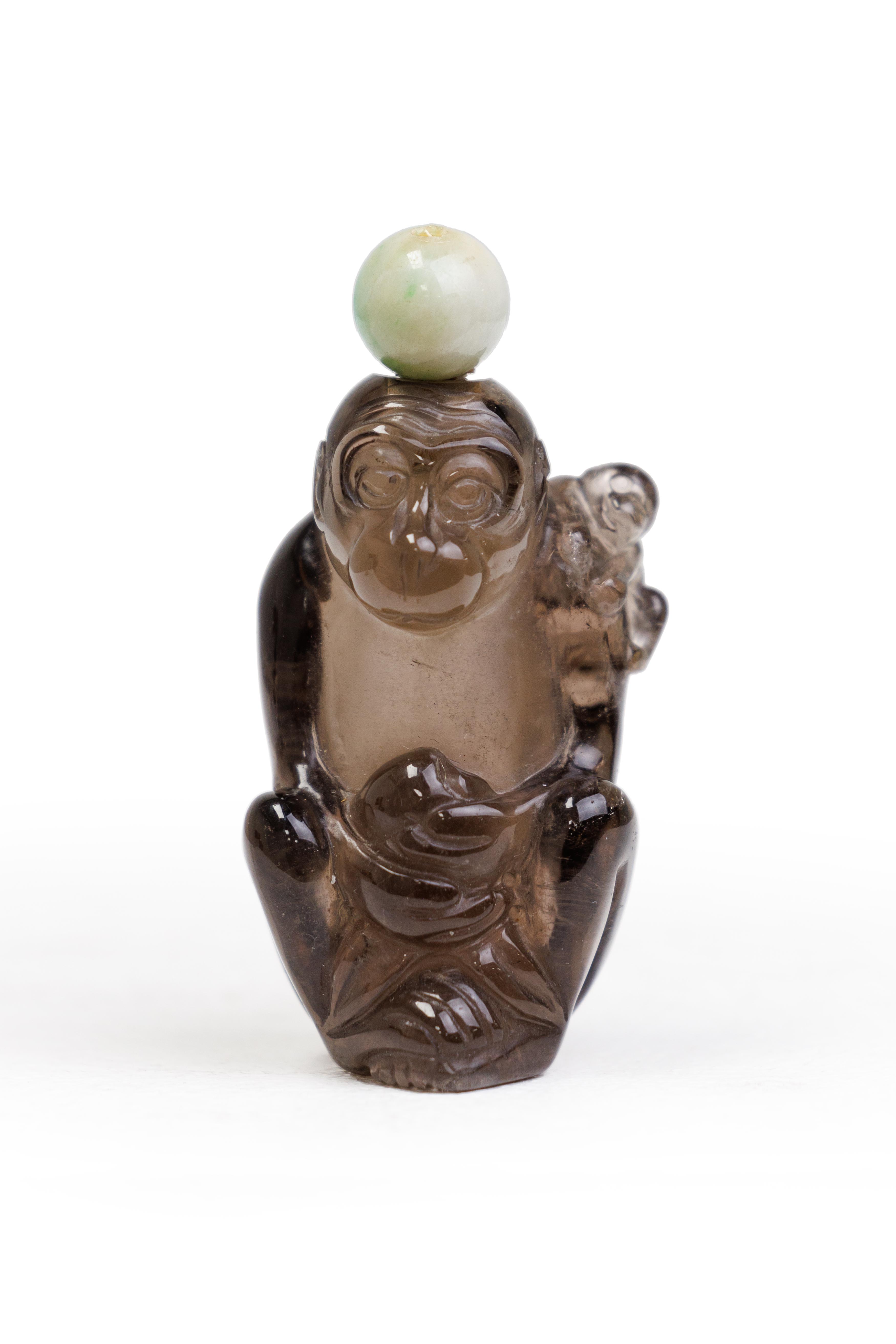 A Chinese 'monkeys' smoky quartz snuff bottle Qing dynasty, 19th century Finely carved as a sea...