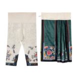 A Chinese emerald green silk embroidered apron skirt and a pair of Chinese cream silk embroidered...