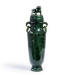 A Chinese spinach jade vase and cover Late Qing dynasty Of slender tapering form, the cover car...