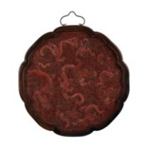 A Chinese carved cinnabar lobed 'dragon' plaque Mid Qing dynasty Finely carved with five dragon...