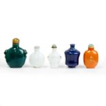 Five Chinese monochrome-glazed snuff bottles Early-late Qing dynasty Comprising: two moulded qi...