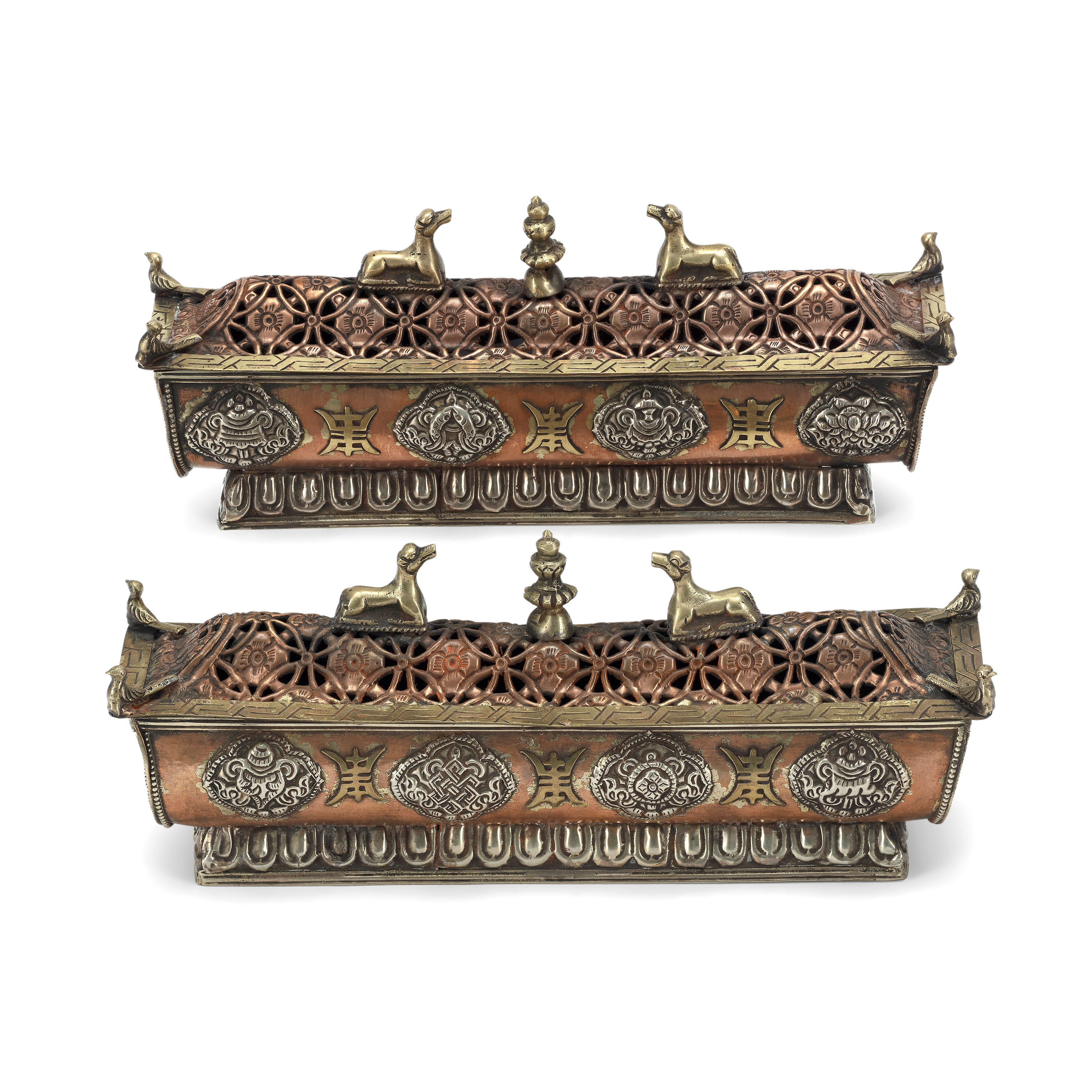 A pair of Tibetan silver and copper incense burners Late 19th century The pierced domed covers ...