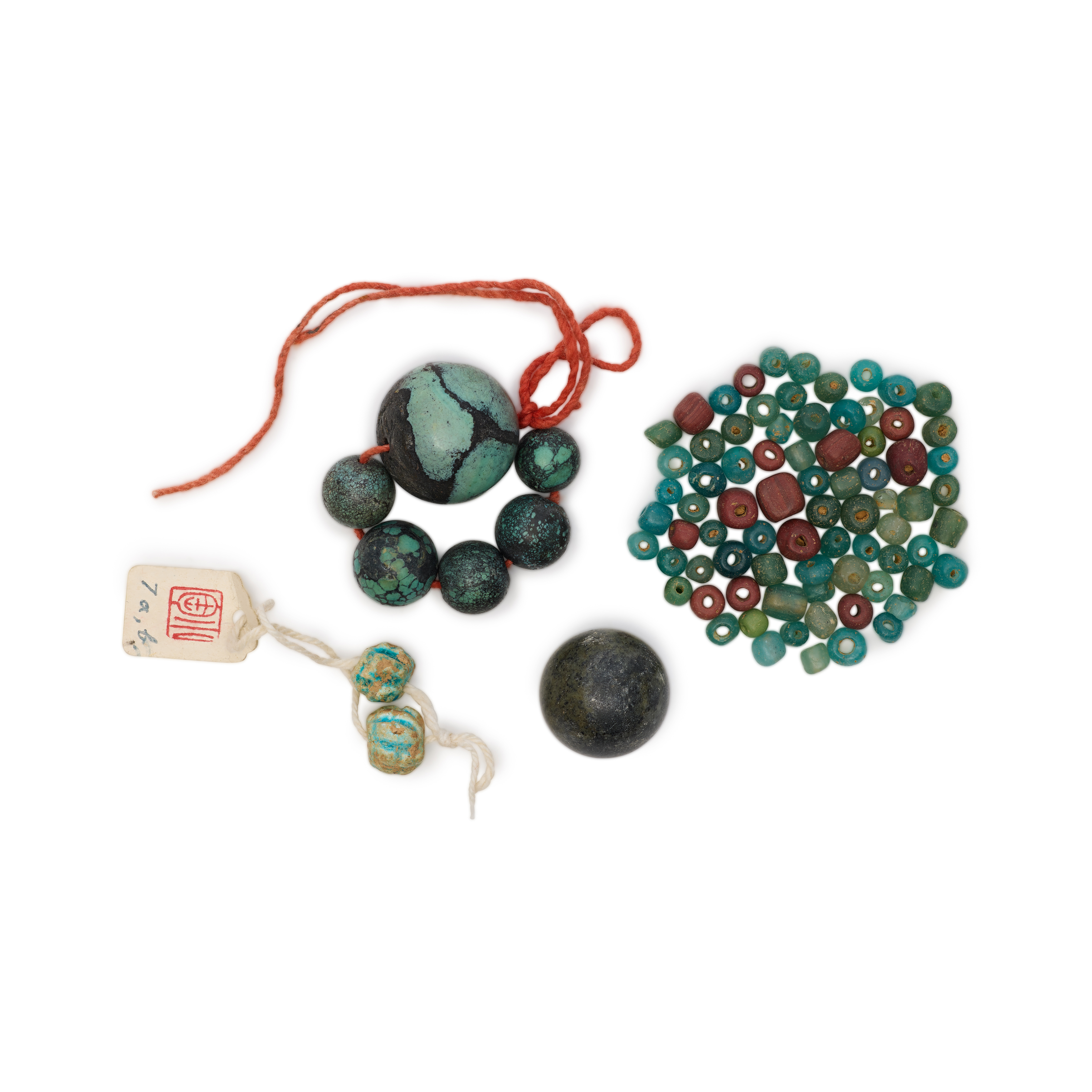 A group of blue-coloured beads Containing six turquoise beads, a mottled greyish bead, a collect...