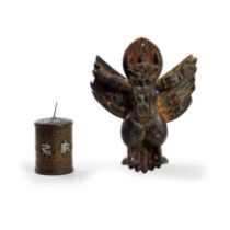 A painted wood figure of Garuda and a copper alloy repoussé prayer wheel with silvered inlay 19t...