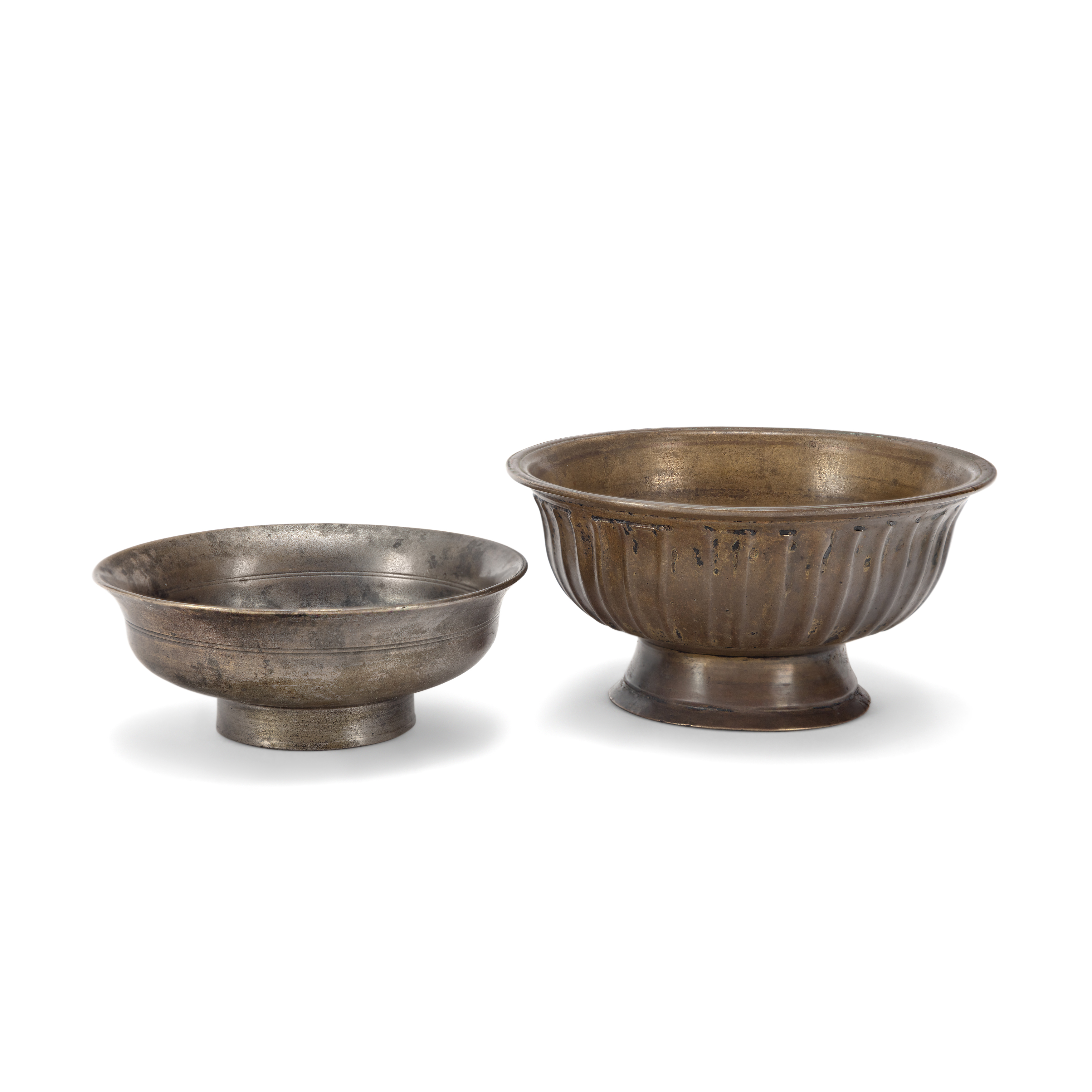 Two Tibetan copper-alloy offering bowls 18th and 19th century The first with ribbed, petalled e...