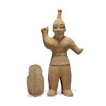 A Japanese Haniwa pottery figure of a warrior and shield Kofun period, 3rd-6th century The warr...
