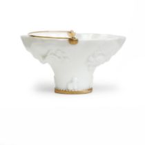 A Chinese Dehua 'blanc-de-Chine' libation cup Qing dynasty, Kangxi period Typically moulded to ...