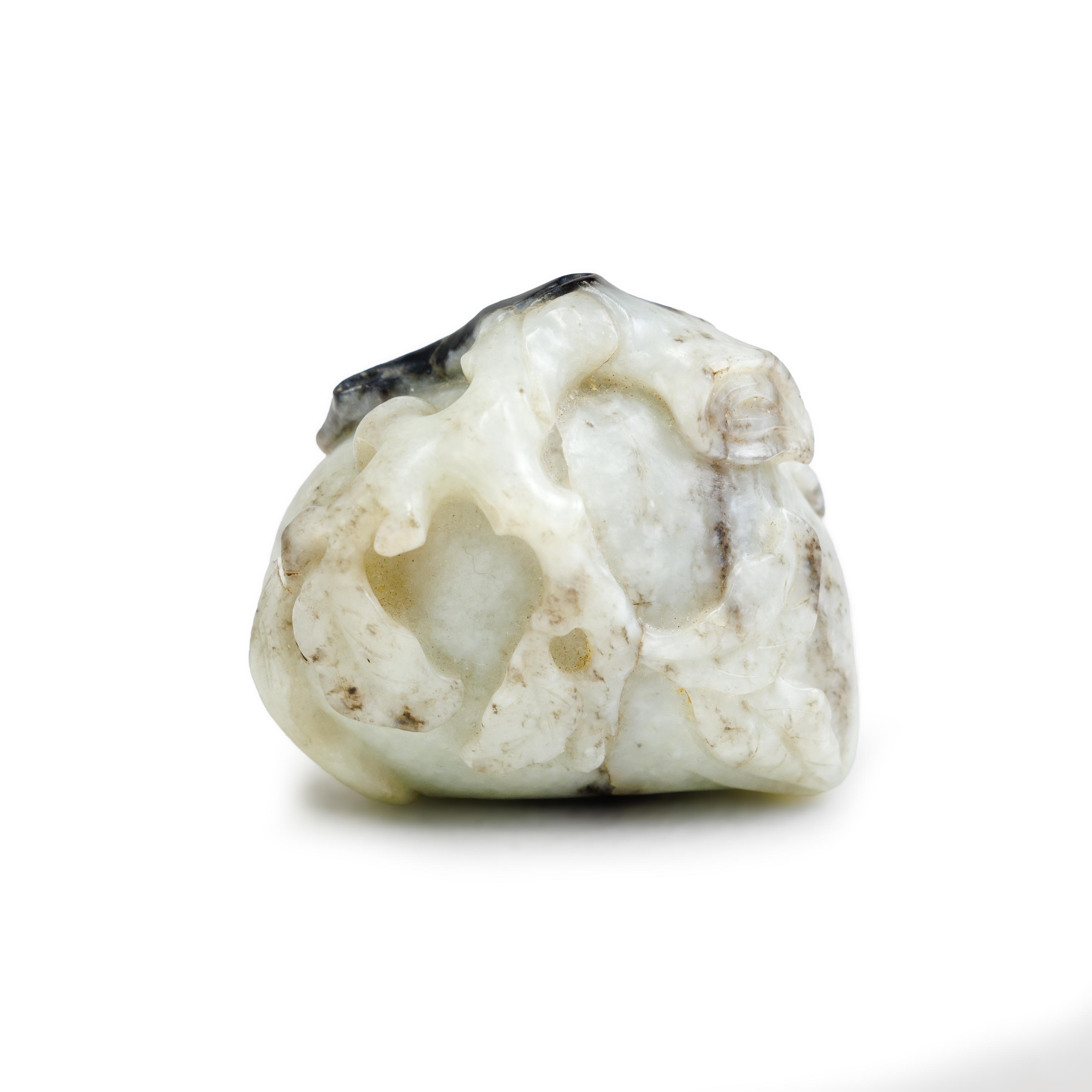 A Chinese black and white jade carving of a peach Ming/Qing dynasty, 17th century Carved in sha... - Image 2 of 2