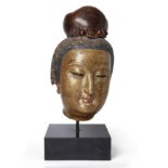A massive Chinese gilt lacquered stucco head of a Bodhisattva Late Ming dynasty The Bodhisattva...
