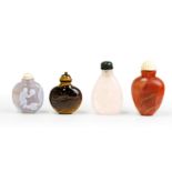 Four Chinese hardstone snuff bottles Late Qing dynasty Comprising: one carnelian agate oviform ...