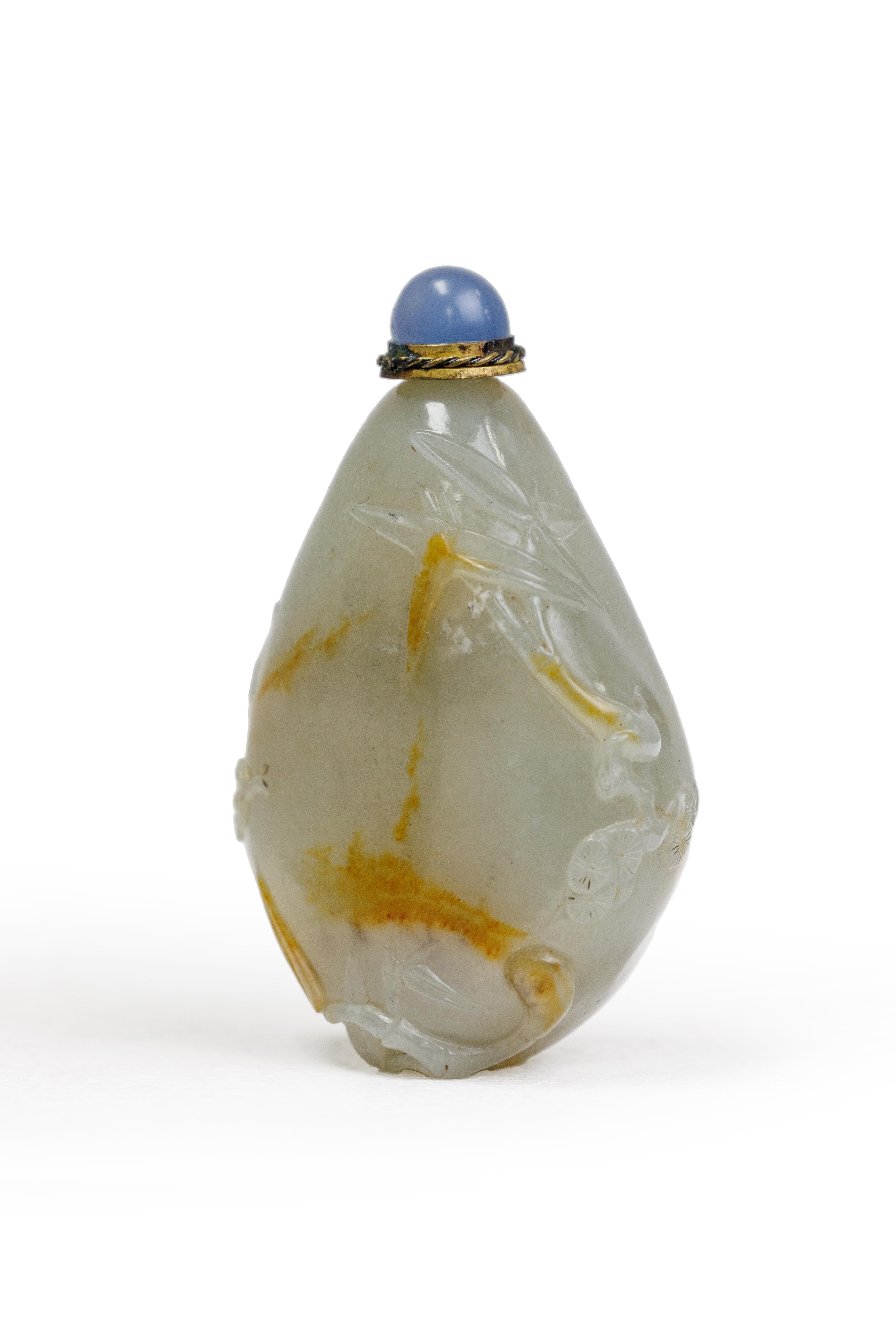 A Chinese pale green and russet jade 'Three Friends of Winter' pebble-form snuff bottle Qing dyn...