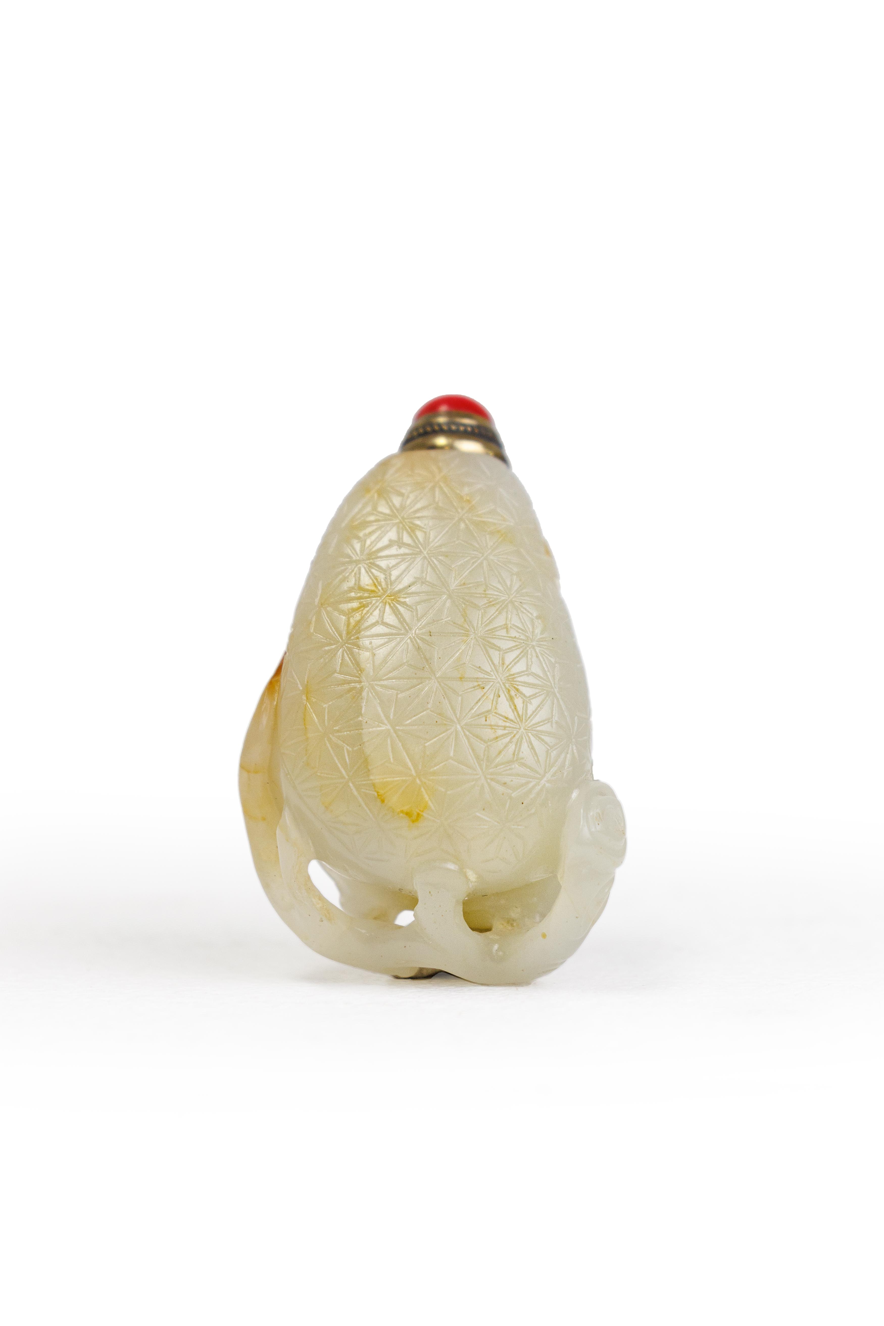 A Chinese pale green and russet jade 'lychees' snuff bottle Qing dynasty, 18th/19th century Car...