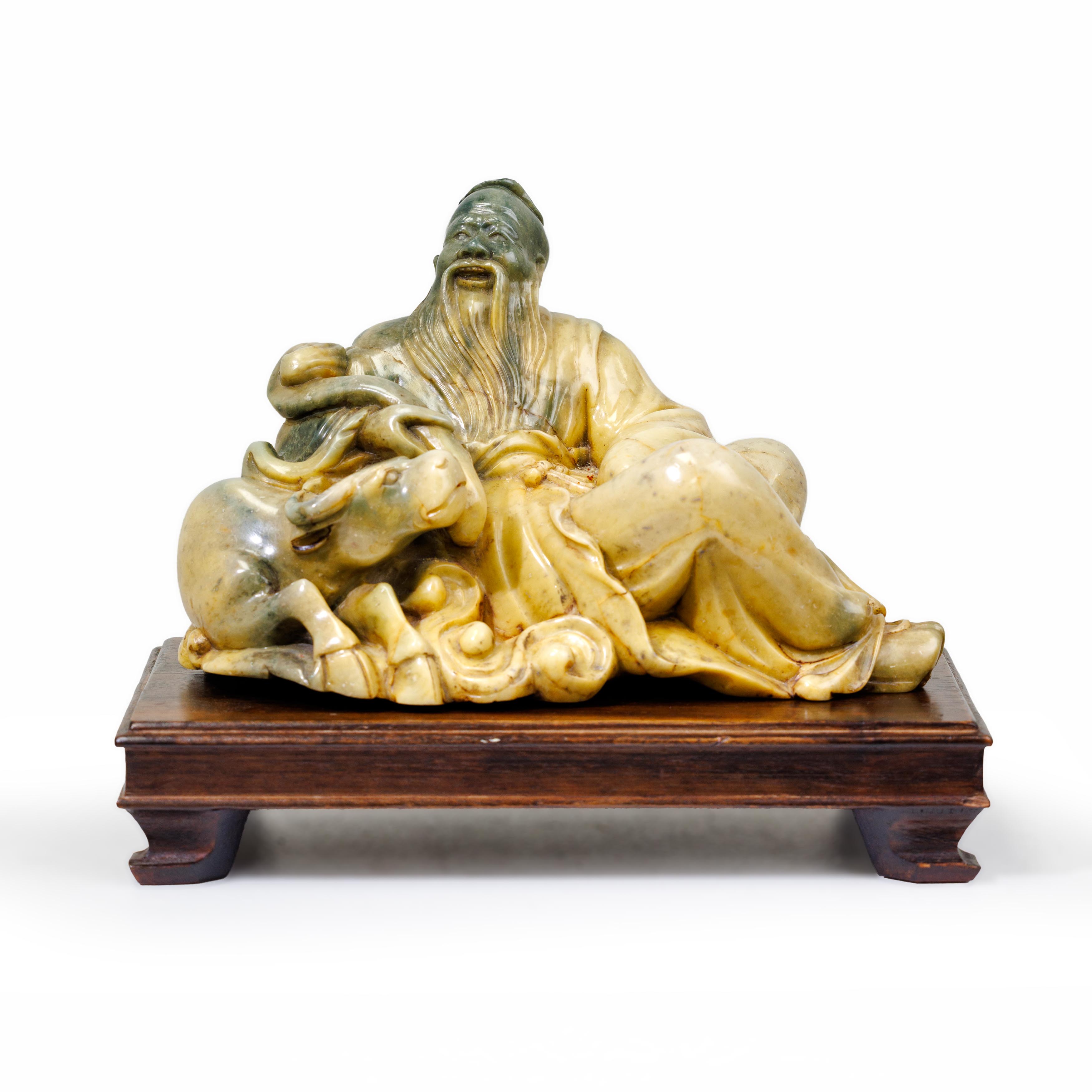 A large Chinese soapstone carving of a sage and buffalo 20th century The sage holding a large r...