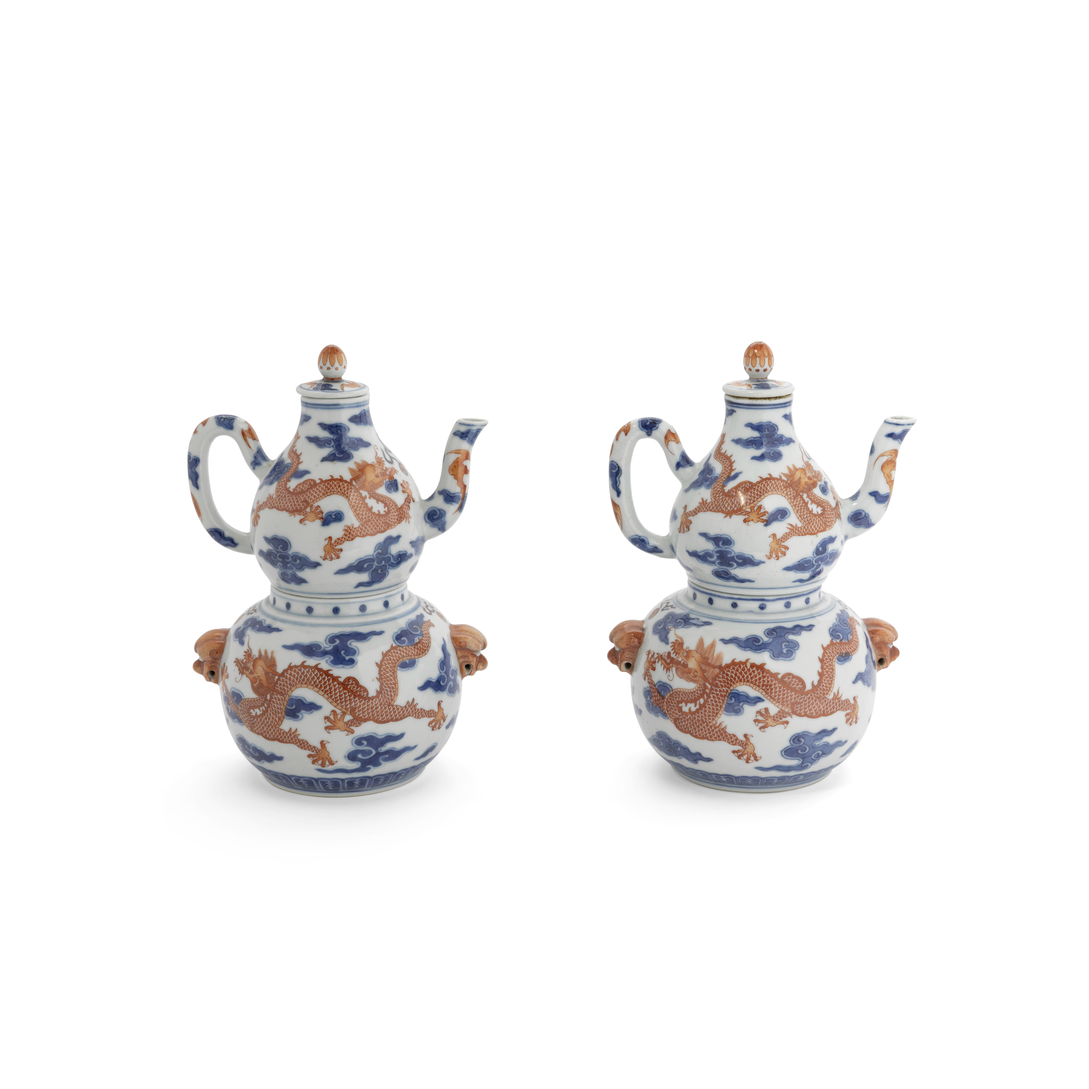 A pair of Chinese blue and white and iron-red double-gourd sectional wine warmers, ewers and cove...