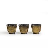 Three Chinese copper alloy square wine cups Late 19th century Incised to each side with Buddhis...