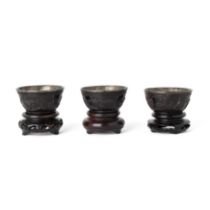 A set of three Chinese coconut wine cups Qing dynasty, 19th century Each with pewter liner, sim...