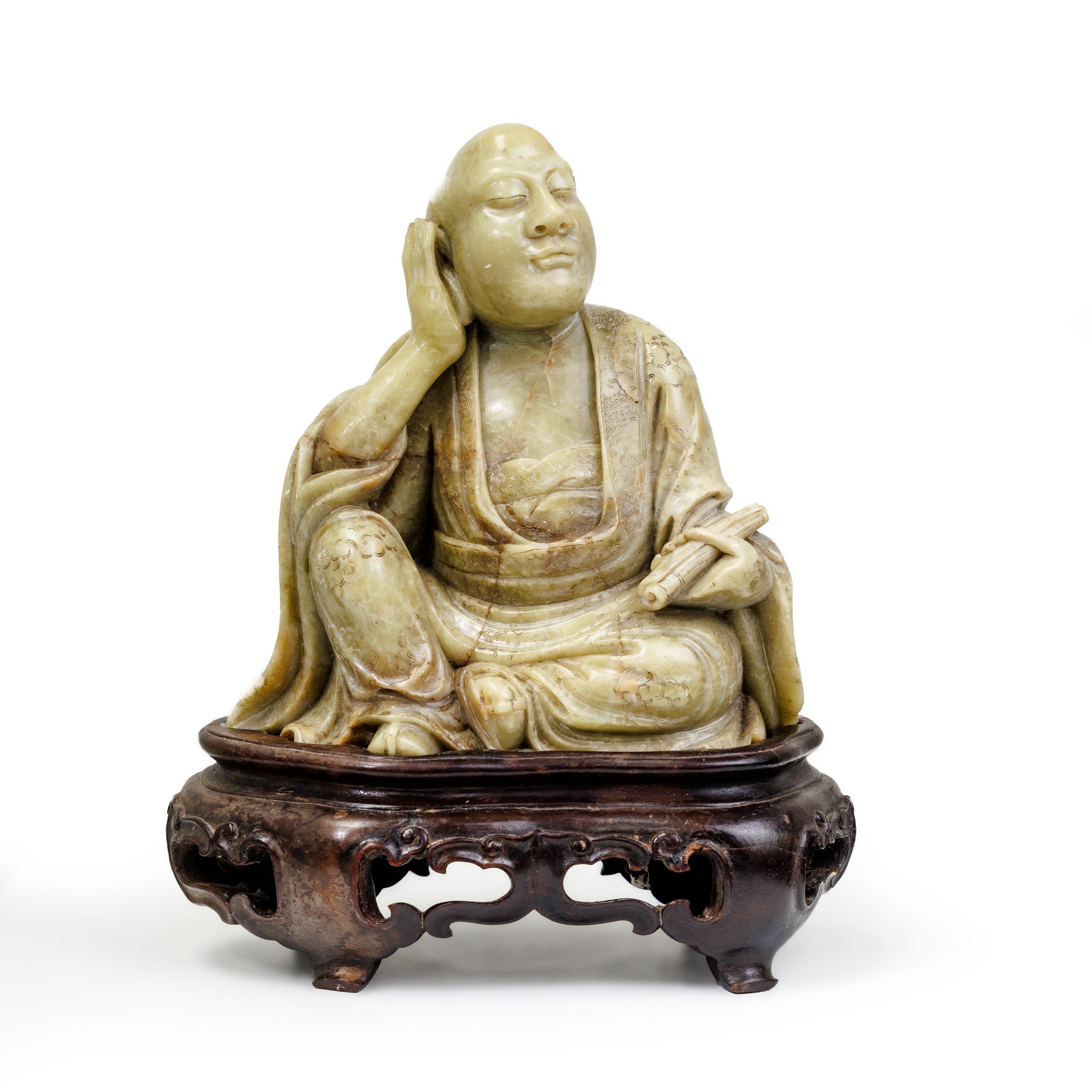 A Chinese soapstone carving of a luohan Qing dynasty The seated figure clad in thickly-folded r...