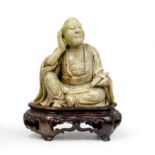 A Chinese soapstone carving of a luohan Qing dynasty The seated figure clad in thickly-folded r...