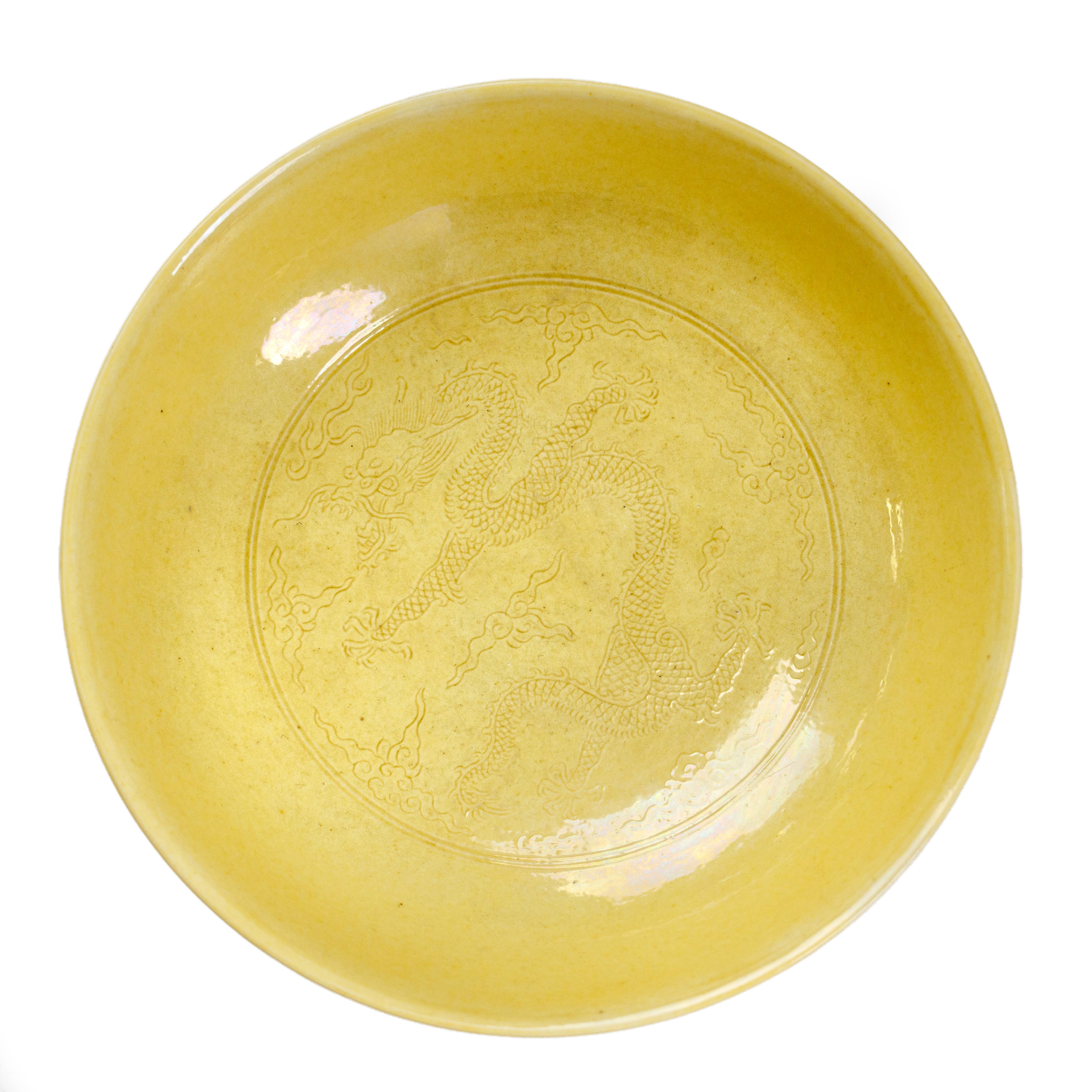 A Chinese yellow glazed 'dragon' dish Qing dynasty, Daoguang mark and period The deep dish with...