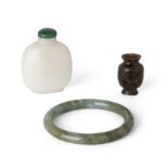 A Chinese green jade bangle and two snuff bottles 19th - 20th century Comprising a green jade b...