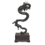 A massive Japanese bronze okimono of a dragon Meiji period, 19th century The three-clawed, scal...