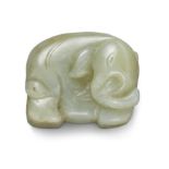 A Chinese green and russet jade elephant Late Qing dynasty The standing animal carved from a gr...