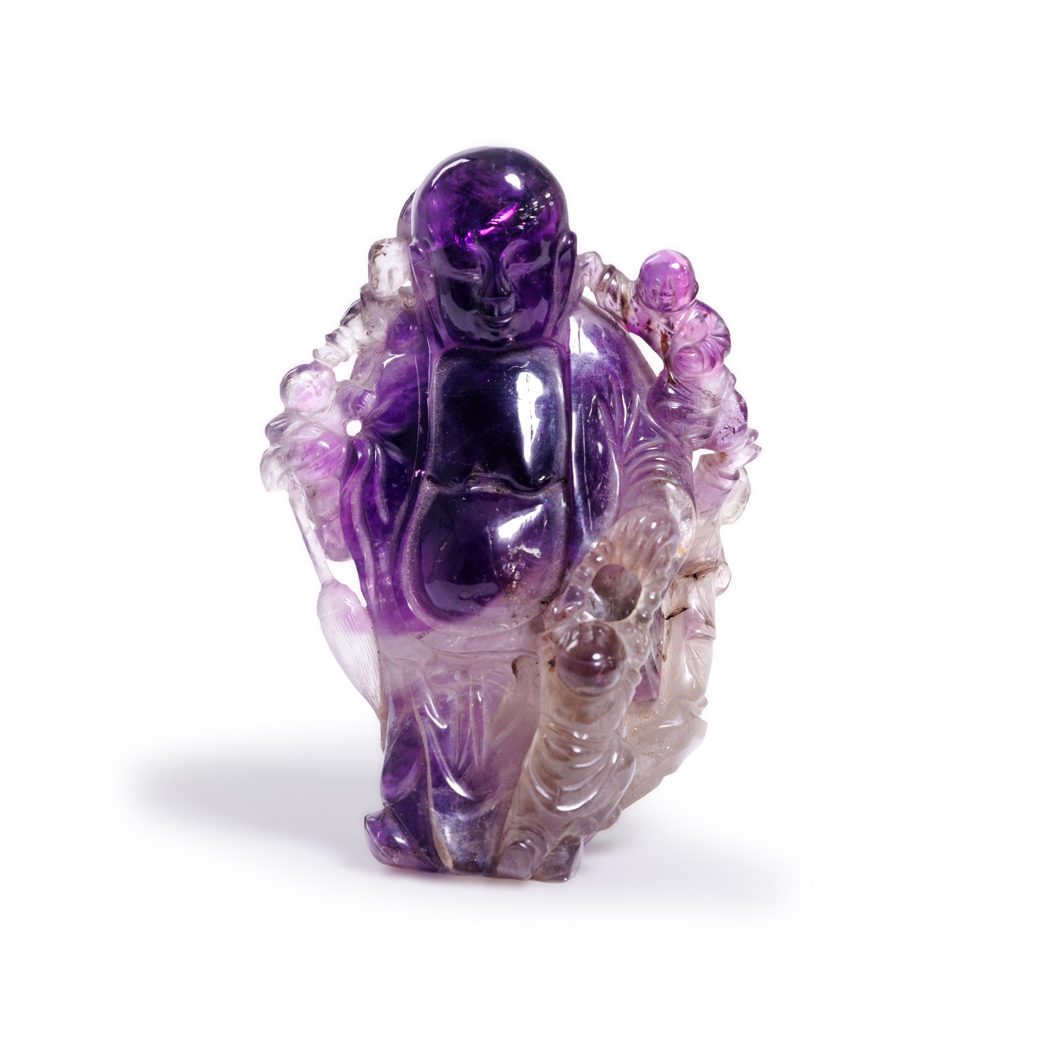 A Chinese amethyst rock crystal carving of Budai Qing dynasty, 18th/19th century Hotei carved s...